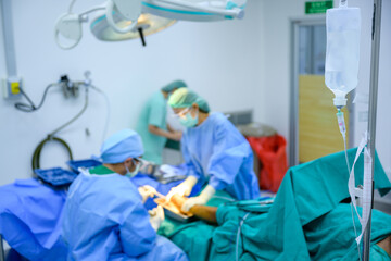 Focus on saline bottles and surgical operating room equipment in hospitals.