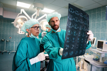 Obraz premium Portrait of intellectual healthcare professionals with at x-ray radiographic image, ct scan, mri
