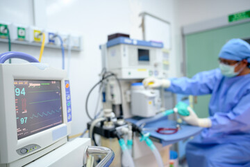 Image focus Electrocardiographs and male doctors examining and preparing surgical instruments in a...