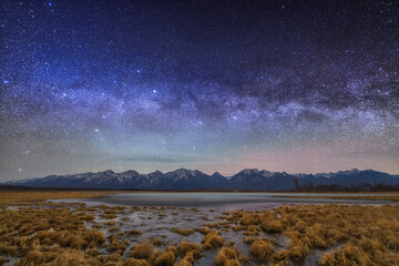 Starry milky way sky over lake and mountains in autumn. - 430331104