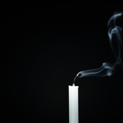 White candles line separating black background that extinguishes religion, faith and peace.