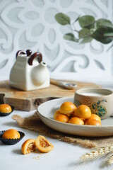 a plate of pineapple tart served with fresh milk on the table