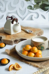 a plate of pineapple tart served with fresh milk on the table