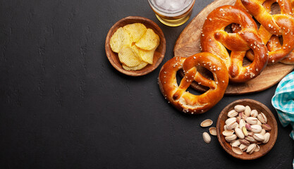Lager beer, nuts, potato chips and fresh homemade pretzel