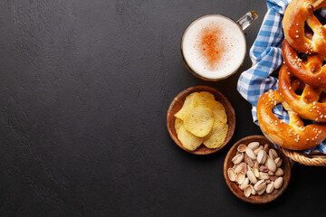 Lager beer, nuts, potato chips and fresh homemade pretzel