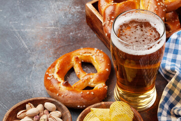 Lager beer, nuts, potato chips and fresh homemade pretzel