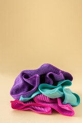 Multicolored microfiber cloths for washing on a neutral beige background, cleaning concept