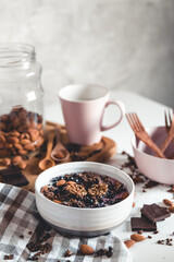 Healthy breakfast. Chocolate granola smoothie and a cup of coffee. Almonds, berries and yogurt in a plate.