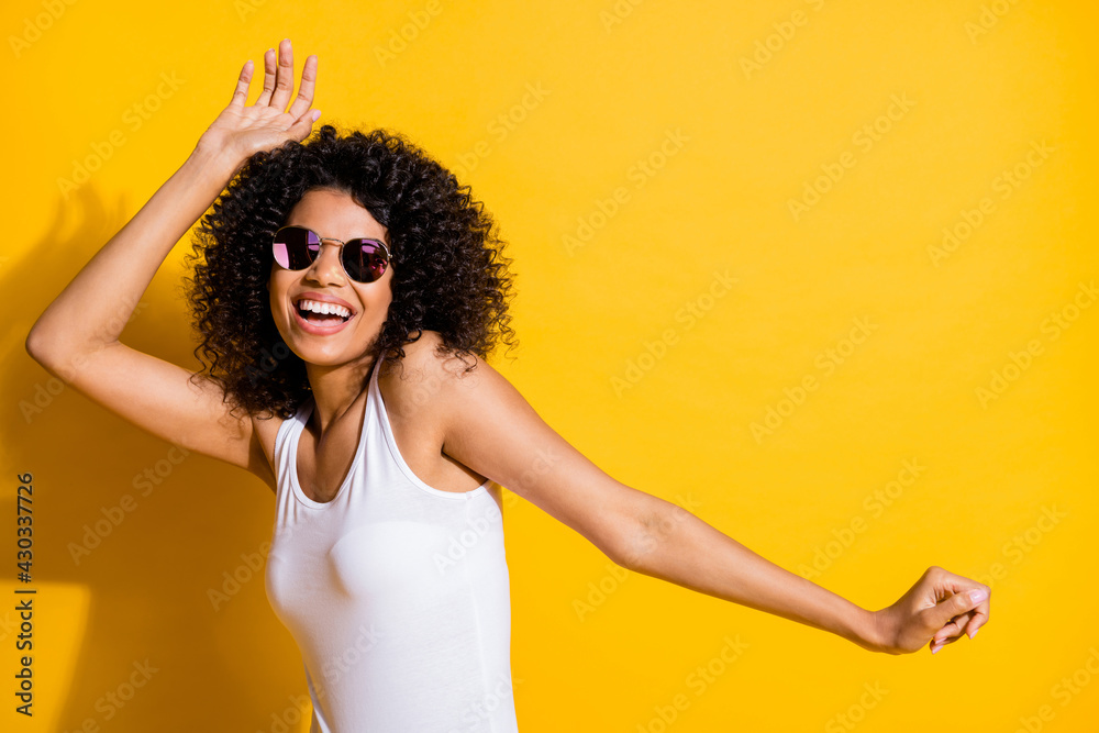 Sticker Photo of charming dark skin woman happy dance wear cool sunglass copyspace isolated on vibrant yellow color background