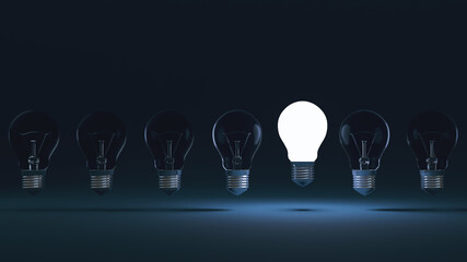 New Idea concept and light bulb that illuminate on blue background.