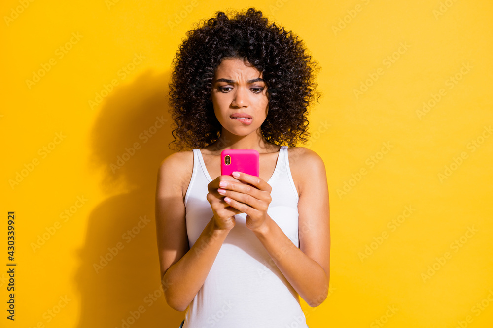 Poster Photo of cute guilty young dark skin lady wear white singlet communicating modern device isolated yellow color background