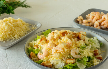 Homemade Shrimp Caesar Salad with parmesa, sauce and Croutons on a white background