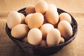 Wooden basket with eggs