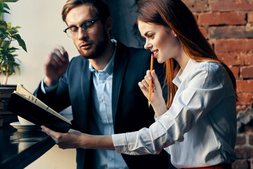 man and woman sitting in a cafe work officials communication