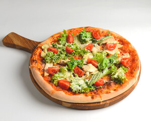 Caesar pizza isolated on white background. Italian pizza with caesar salad filling.
