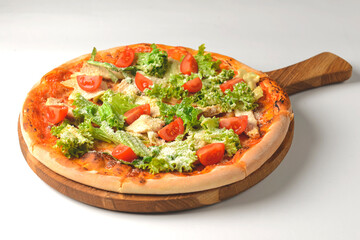 Caesar pizza isolated on white background. Italian pizza with caesar salad filling.