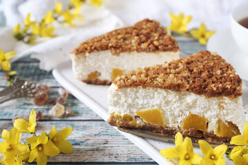 Ricotta (cottage cheese) grated tart from cookies and tea cup, blooming forsythia decor