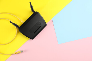 Modern Wi-Fi router on color background, top view. Space for text