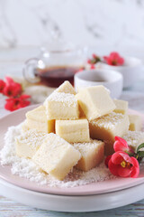 Apple gelatin dessert. Sugar free pastila. Homemade apple marshmallow cubes in coconut flakes and tea