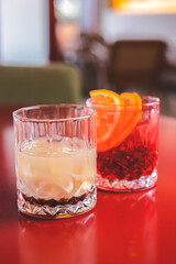 Cocktails with fruits and berries in a bar or restaurant. Blurred background. Alcoholic beverages.
