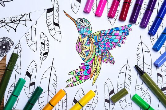 Felt tip pens on antistress coloring page, top view