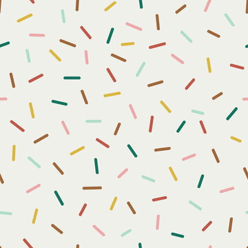 Seamless vector pattern with decorative sprinkles. Colourful donut glaze or ice cream top festal background. Celebrating Christmas party dash confetti backdrop.