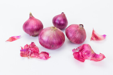 Fresh red onions and peel are put on white background. Natural Thai herb theme.