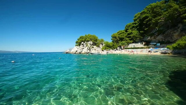Panorama of the sea coast of Croatia. Brela. Makarska Riviera.  Beach and Adriatic Sea. Summer season for vacation and recreation. Seascape in the daytime.