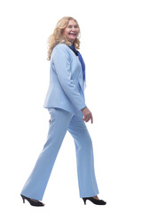 side view. confident woman in a pantsuit striding forward.