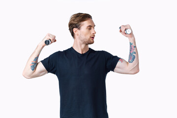 man with pumped up muscles of arms and dumbbells black t-shirt white background