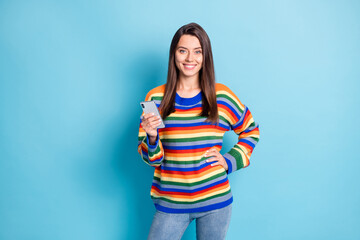 Fototapeta premium Photo portrait of girl amazed holding smartphone browsing internet isolated on vibrant blue color background copyspace