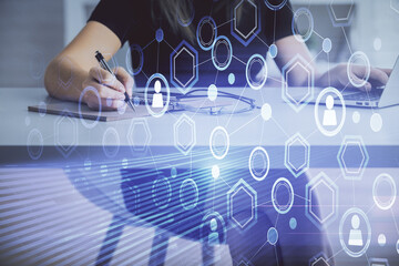Double exposure of woman hands typing on computer and social network theme hologram drawing. People media concept.