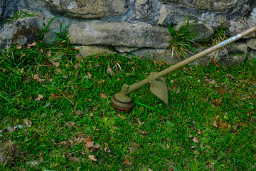 Green grass cutting equipment tool. cutting garden tools close-up. Garden work tool