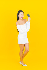 Portrait beautiful young business asian woman with smart mobile phone and credit card