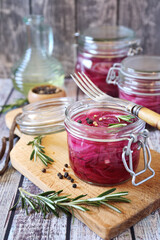 Pickled red onion salad in jars, spices and rosemary