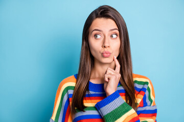 Portrait of attractive curious girlish brown-haired girl pout lips thinking copy space isolated over bright blue color background