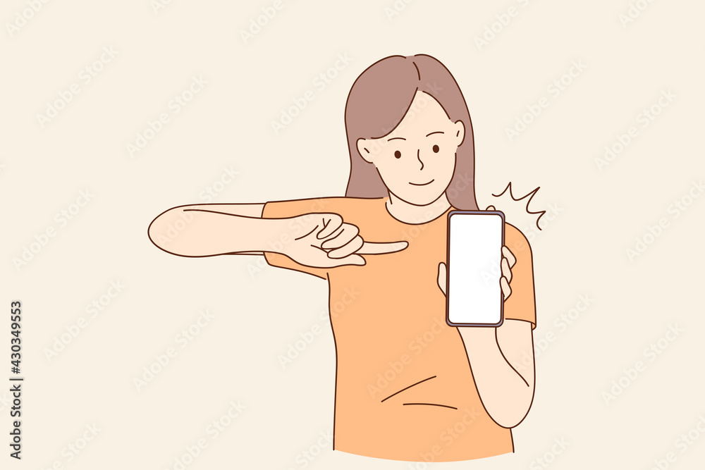 Wall mural Copy space, technology concept. Young smiling girl cartoon character sitting pointing with finger at mobile phone with blank white screen vector illustration 