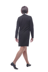 in full growth. a young business woman striding confidently away .