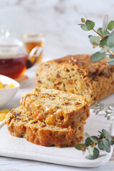 Traditional English tea raisins cake with candied orange, egg-free cake and cup of tea