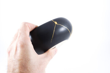 Black kintsugi bowl restored with real gold