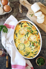 French cuisine. Vegetable zucchini clafoutis with goat cheese in ceramic bakeware