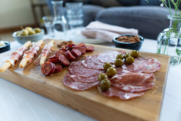 Macro close up pan dolly footage over a charcuterie board. Cold cured meats include chorizo, salami and prosciutto. Artisan food footage concept filmed with natural daylight.