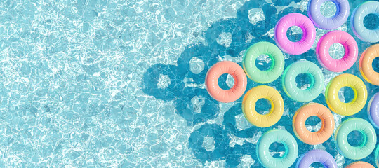 swimming pool seen from above with many rings floating - obrazy, fototapety, plakaty