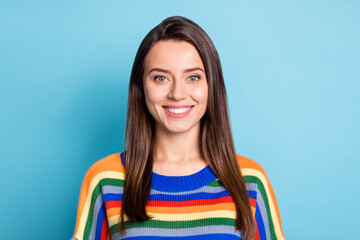 Fototapeta premium Photo portrait of cheerful girl smiling in colorful striped sweater isolated on bright blue color background