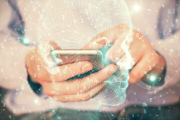 Double exposure of man's hand holding and using a digital device and brain hologram drawing. Data concept.