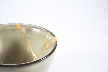 Beige kintsugi bowl with gold scars
