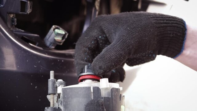 Replacing the halogen bulb in the car's fog lamp. Self-service car repair concept.