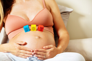 Pregnant woman with girl word made of color blocks