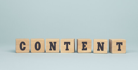 The word CONTENT made from wooden cubes on blue background