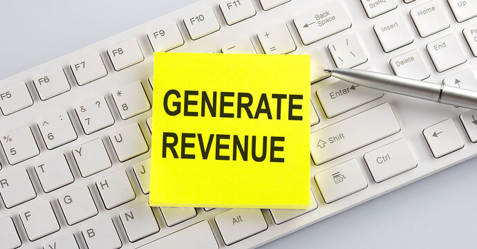 Words GENERATE REVENUE written on stickers on a computer keyboard